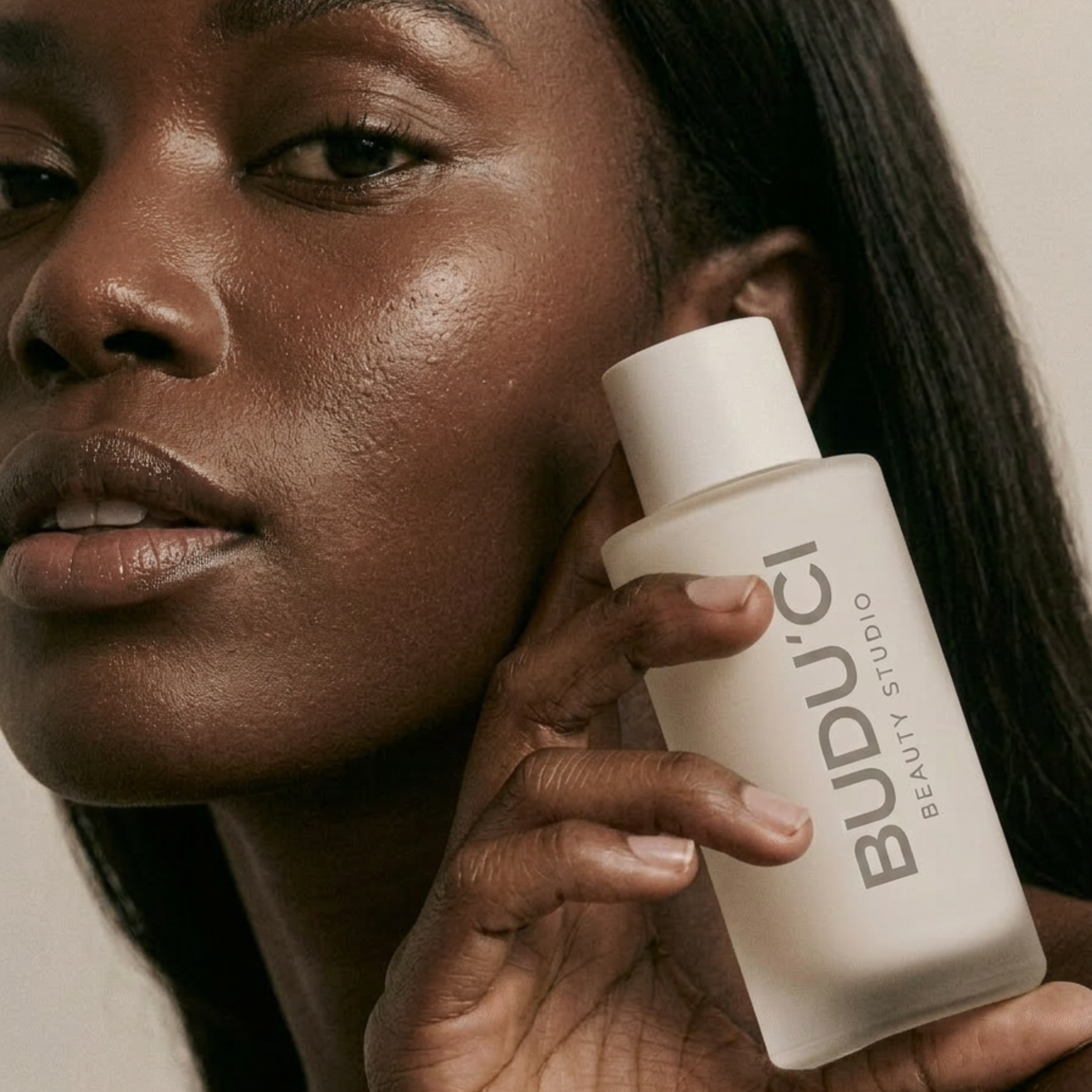 A Buduci Beauty Studio product held up to the skin